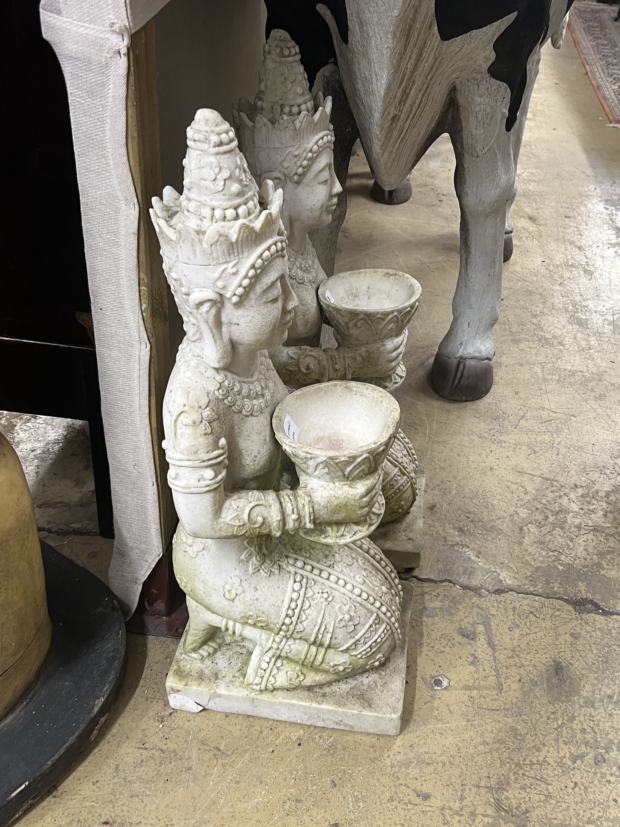 A pair of Thai style composition faux marble kneeling attendant garden ornaments, height 85cm